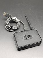 Front/top view of MAG 254 box with attached antenna and coiled power cable