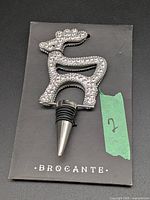 Full view of rhinestone deer bottle stopper in original Brocante card