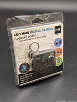 Front view of sealed Hip Street keychain digital camera package showing camera, key ring and feature list