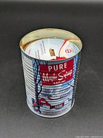 Angled view of sealed 540 ml maple syrup scented candle can with wooden wick visible