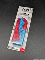 Front view of sealed package showing red and blue coiled laces