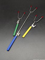 Three telescopic roasting forks showing handle colors and prong tips