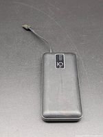 Front view showing attached cable and overall condition of the power bank