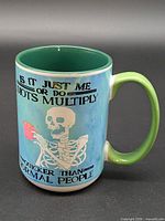 Full view of mug showing skeleton graphic and text