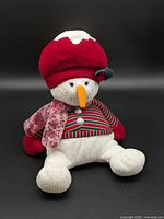 Front view of entire snowman plush showing hat, scarf, striped vest, limbs and facial features