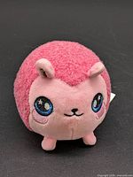 Front view of pink hedgehog plush showing face and overall condition