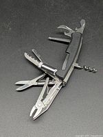 Multitool fully opened showing pliers, scissors, saw, file, corkscrew, screwdrivers
