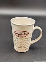 Front view of cream Tim Hortons ceramic mug with logo and script design