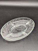 Full view of clear glass oval divided tray with three sections