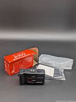 Camera front, box, leaflet, plastic bag visible