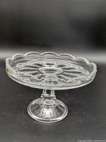 Full side view of pressed glass pedestal cake stand