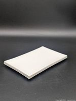 Angled view of white ceramic rectangular tray showing form and condition