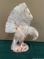Front angled view of stone eagle sculpture