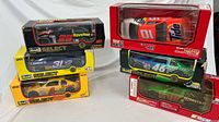 All six boxed 1:24 NASCAR die-cast cars stacked