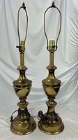 Full view of both brass table lamps showing overall design, height and cords
