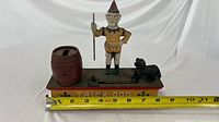 Full view showing clown, dog, barrel, base with TRICK DOG and measuring tape indicating length