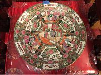 Top view of the entire 18 inch decorative porcelain plate showing central hand-painted scene and floral border