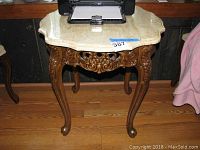 Side table showing marble top, printer placed on top for scale