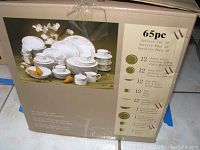 Photo of the original box showing the variety and quantity of dishware included in the 65 piece set with Wellesley pattern.