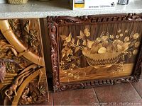Carved wood panel with flowers, fruit basket, and decorative frame