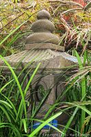 Top ornamental finial piece of the cement pagoda with rounded tiered design.