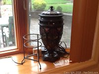 Full view of lamp and plant stand on window sill