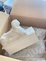 Bookend showing Sphinx figure in shipping box