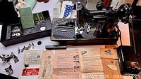Top-down view of machine with accessory box, attachments, manuals laid out