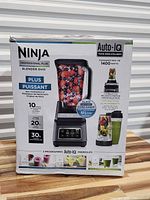 Front of boxed Ninja Professional Plus Blender Duo set showing motor base, pitcher, Auto-iQ features, 1400 W spec