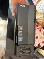 Front and side view of Acer SFF desktop showing brand logo and port array