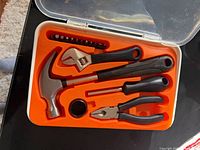 open tool kit case showing tools in orange insert