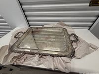 Full view of rectangular silver-plated tray showing handles and ornate border