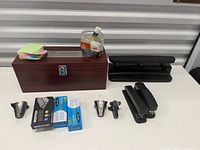 Overall view: wooden box, hole punch, staplers, staple removers, staple boxes, sticky notes, tape items