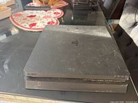 Top view of PS4 Slim showing scratches and wear
