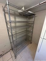 Full view of chrome wire shelving rack in situ showing six shelves and casters