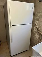 Front view of white GE top-freezer refrigerator