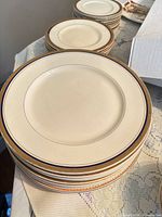 stack of ivory plates with cobalt and gold rims
