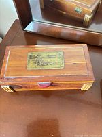 cedar wood keepsake box closed, showing metal plaque on lid