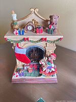 Resin fireplace figurine showing teddy bears, gifts, stocking and rocking horse