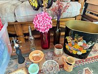 overview of lot showing wastebasket, vases, bottles, bowls, stein, jewelry holder, faux florals