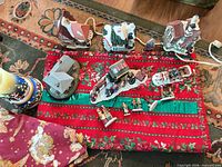 Top view showing four lighted houses, figurines and tree