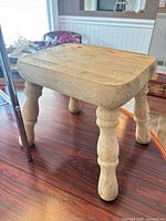 Close view of light wood step stool on tabletop