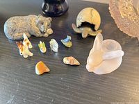 Group shot showing resin bear, miniature glass animals, frosted pink rabbit holder, ceramic globe starfish piece, pink carnival glass bowl edge