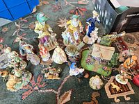 Group shot of all porcelain and resin figurines on carpet
