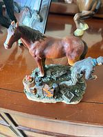 Brown horse and groom on detailed base with baskets and tools