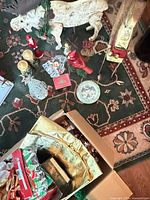 Overview showing moose, reindeer, candles, figurines, plate, ribbons in box