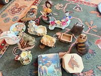Full group view of all figurines, coasters, boxes and bell