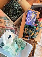 Tangled green-wire C9 LED string lights and boxed set in cardboard container