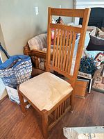 Full view of chair showing oak frame, slatted back, stained seat