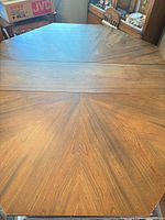 Top view of octagonal table with installed leaf showing sunburst veneer pattern